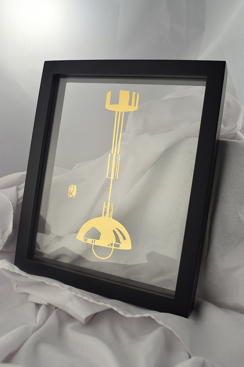 black floating frame with glass gilded with image of bauhaus hanging lamp