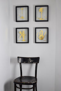 black floating frames with glass gilded images of bauhaus designs