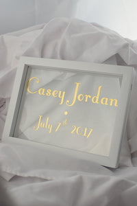 white floating frame with gilded glass, new born gold sign